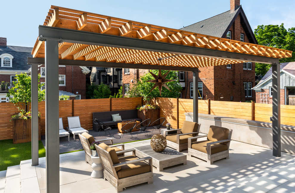 Mid-sized trendy backyard concrete paver patio photo in Chicago with a pergola