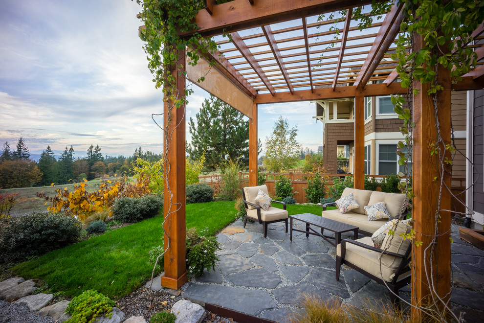 Patio - traditional backyard patio idea in Seattle with a pergola