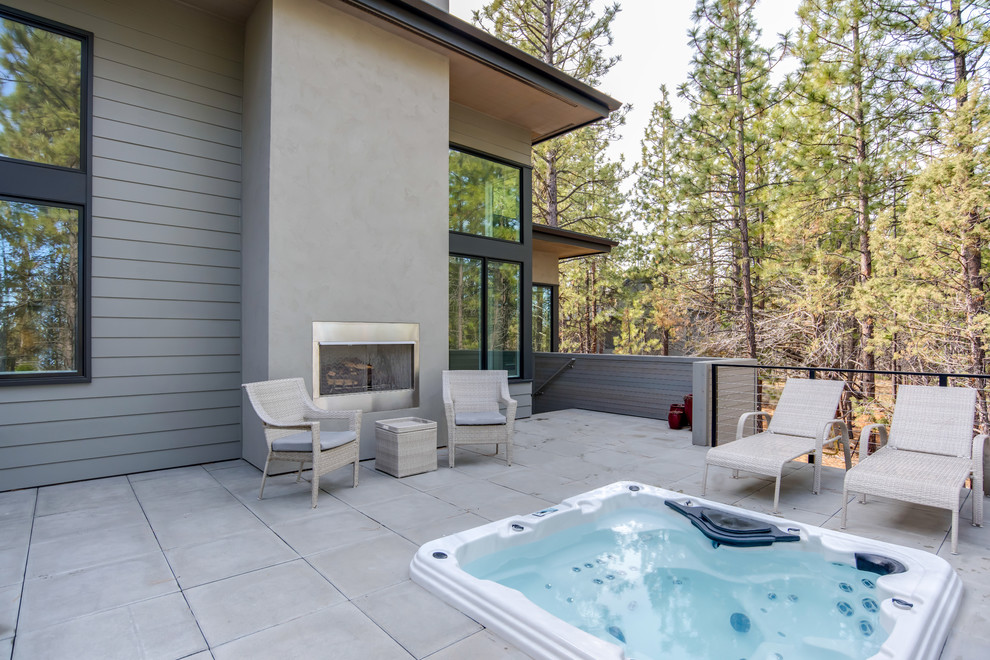 Inspiration for a large modern back patio in Other with concrete paving and no cover.