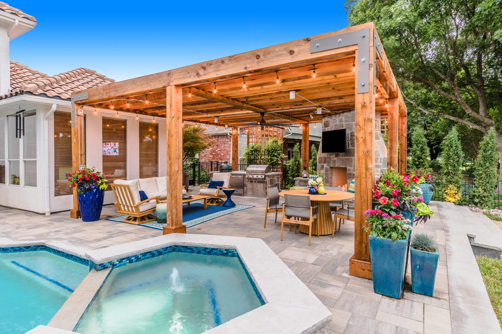 Large transitional backyard concrete paver patio photo in Dallas with a fireplace and a pergola