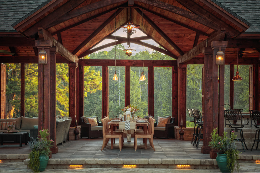 Diseño de patio rústico extra grande en anexo de casas con adoquines de piedra natural