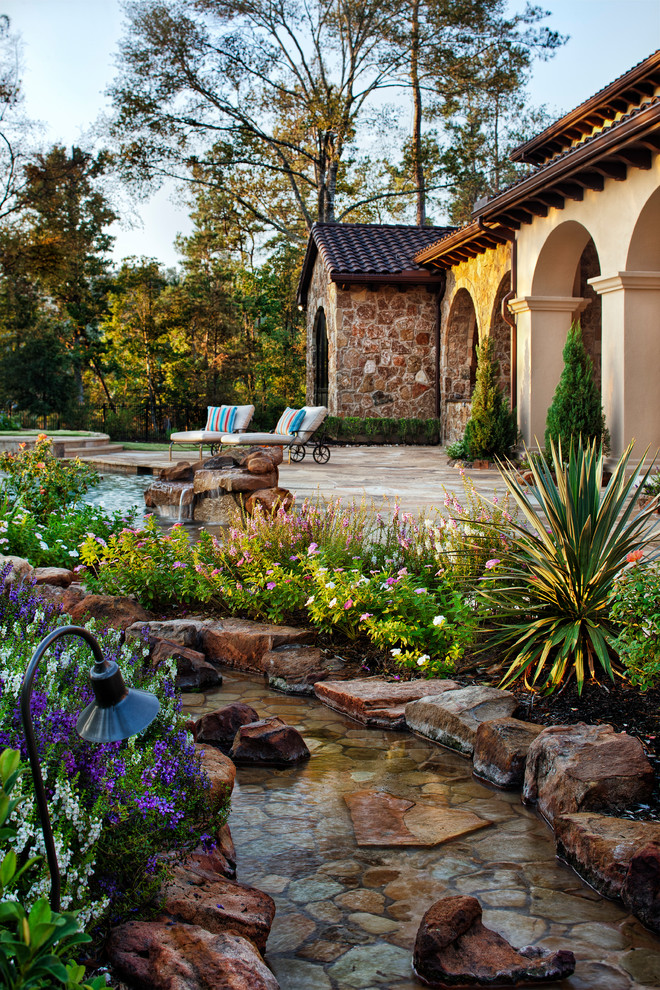 Photo of a mediterranean patio in Austin with a water feature.