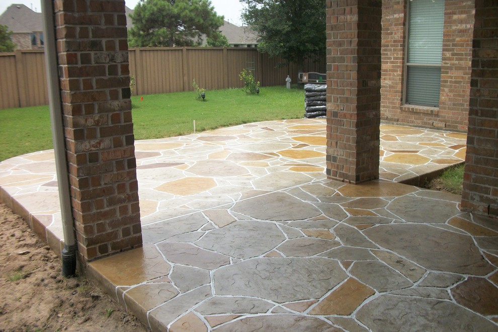 Inspiration for a medium sized classic back patio in Houston with natural stone paving and a roof extension.