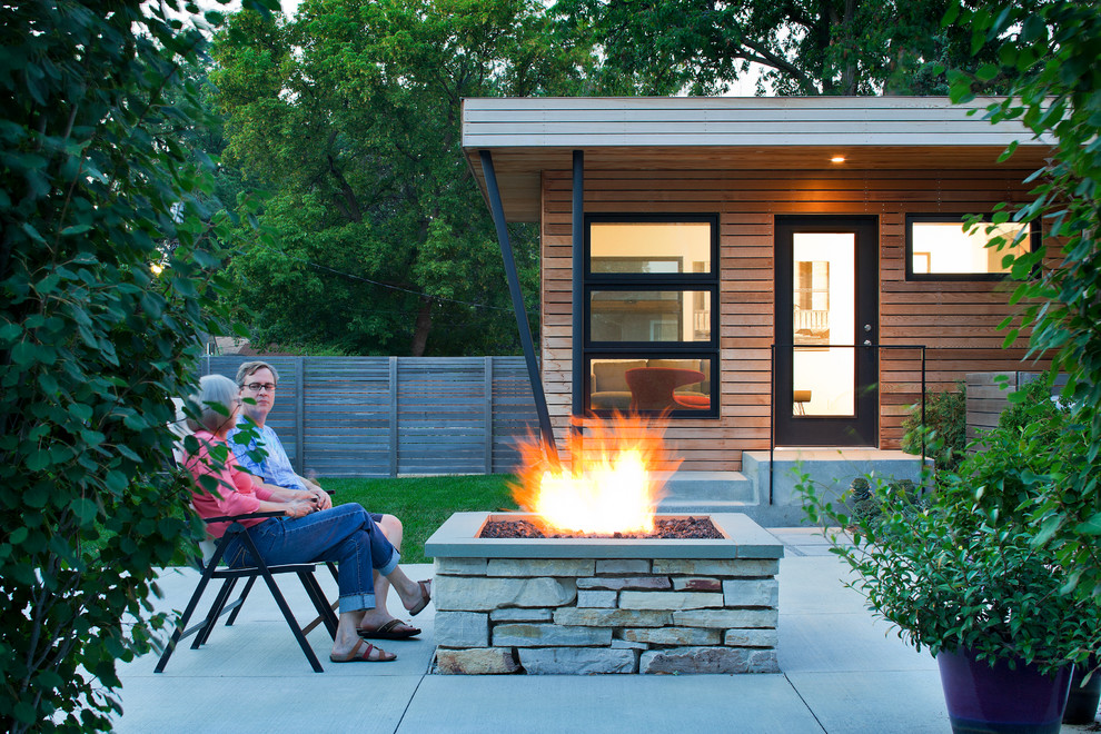 Photo of a medium sized contemporary back patio in Minneapolis with a fire feature and concrete paving.