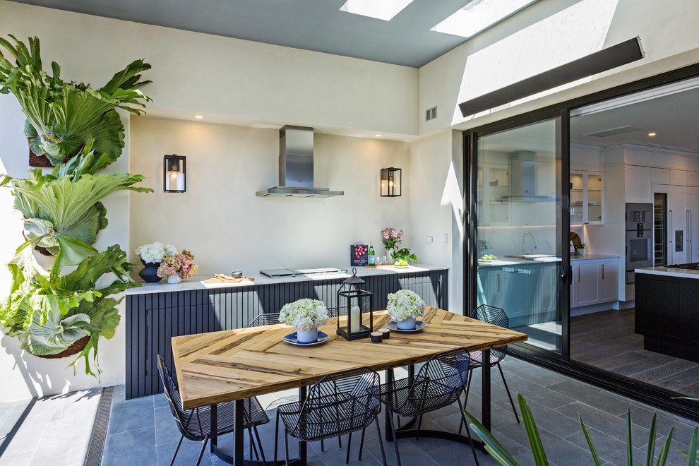 Example of a trendy patio kitchen design in Melbourne with a roof extension