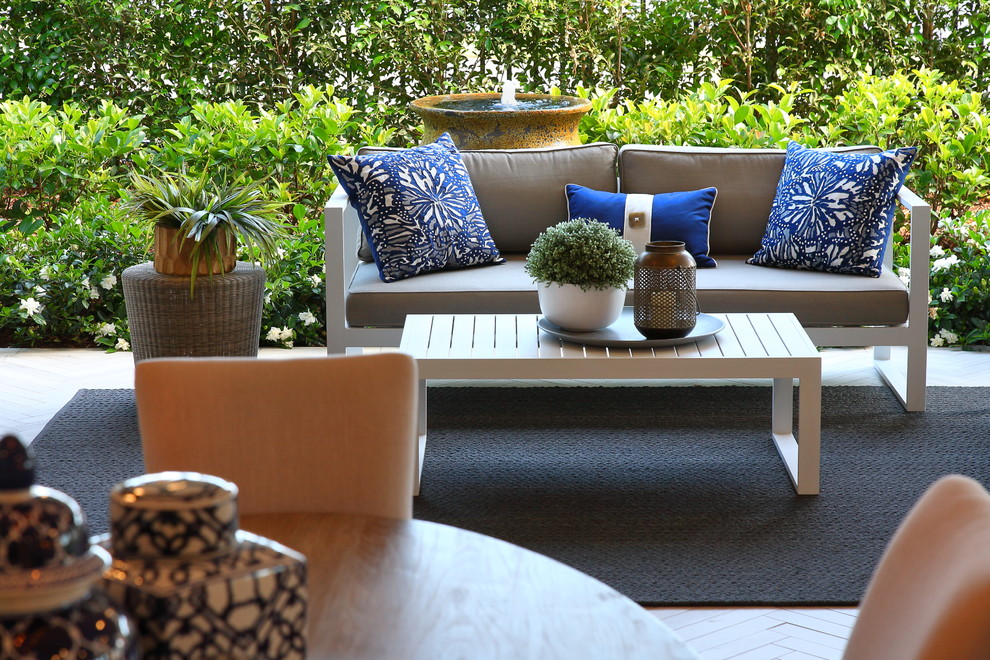 Inspiration for a small contemporary back patio in Sydney with a water feature, tiled flooring and a roof extension.