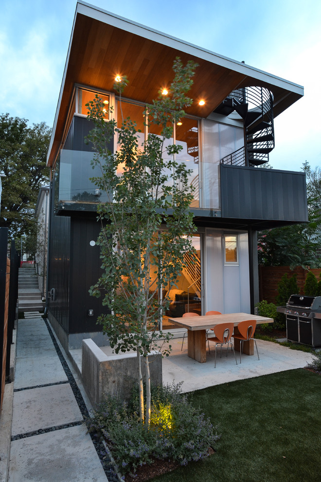 Photo of a medium sized contemporary back patio steps in Denver with concrete slabs and no cover.