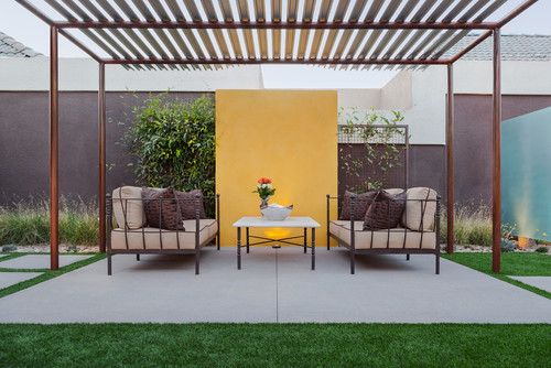 yellow wall with metal trellis patio