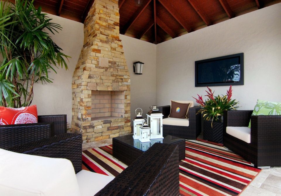 This is an example of a mediterranean back patio in Orlando with a fire feature, concrete paving and a gazebo.