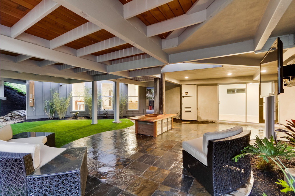 Inspiration for a contemporary patio in San Diego with a roof extension.