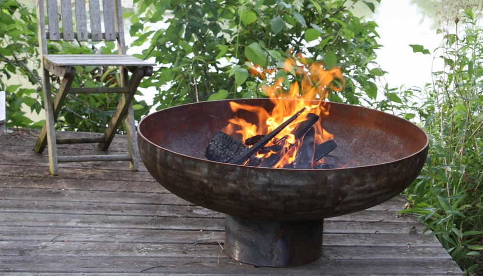 Inspiration for a modern patio remodel in Grand Rapids with a fire pit