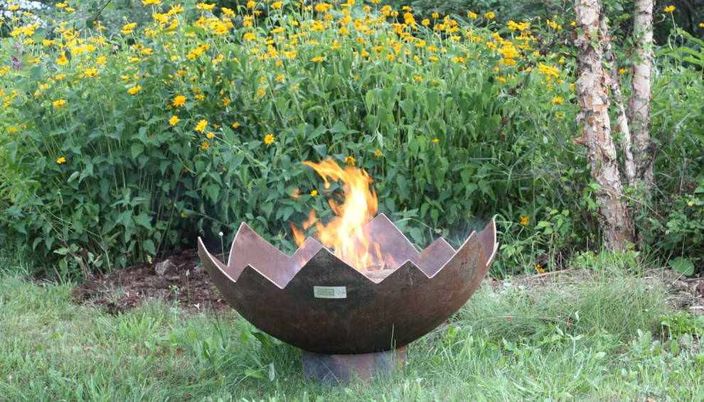 Inspiration for a modern patio remodel in Grand Rapids with a fire pit
