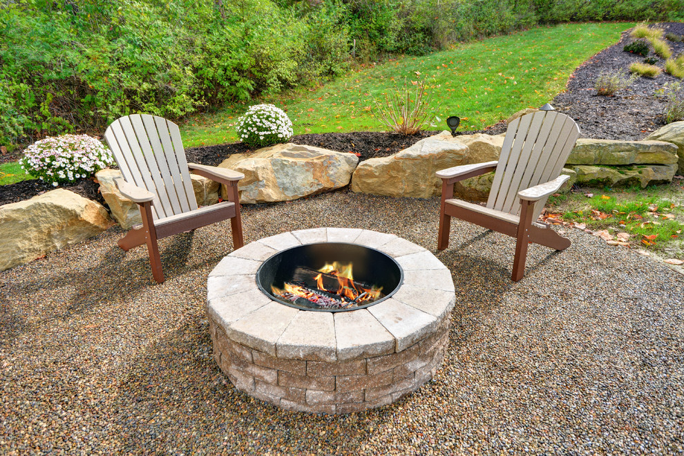 Inspiration for a mid-sized timeless backyard patio remodel in Other with a fire pit