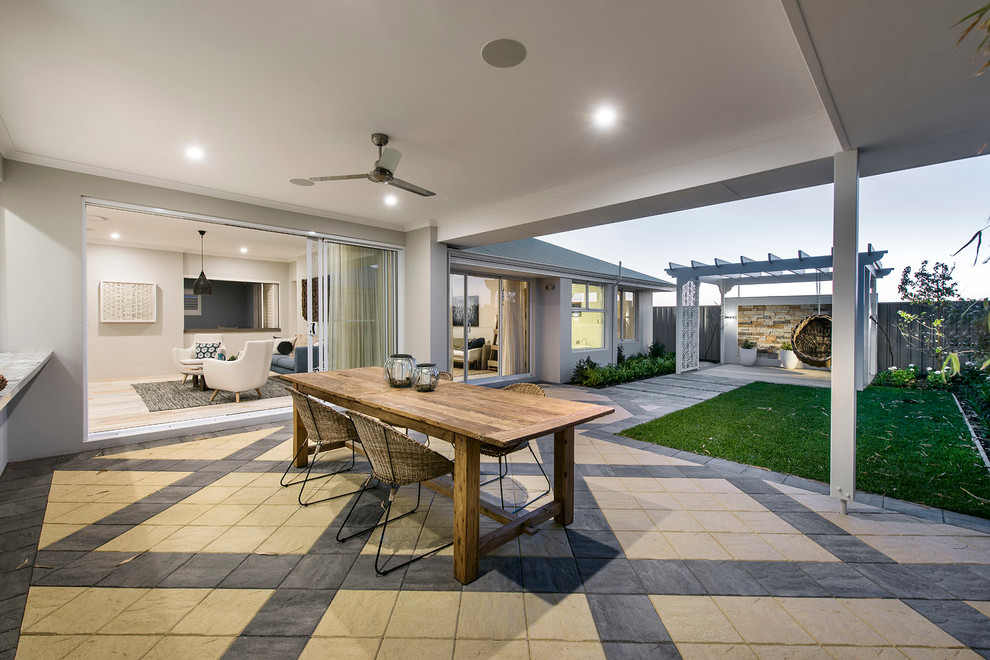 Design ideas for a large beach style back patio in Perth with concrete paving and a roof extension.