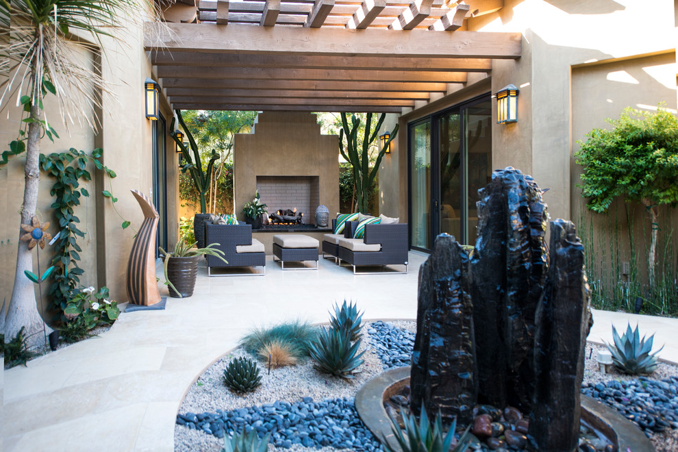 Large contemporary courtyard patio in Other with a fire feature, natural stone paving and a roof extension.