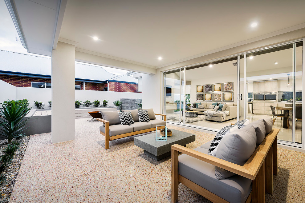 Inspiration for a medium sized modern back patio in Perth with a fire feature, concrete slabs and a roof extension.