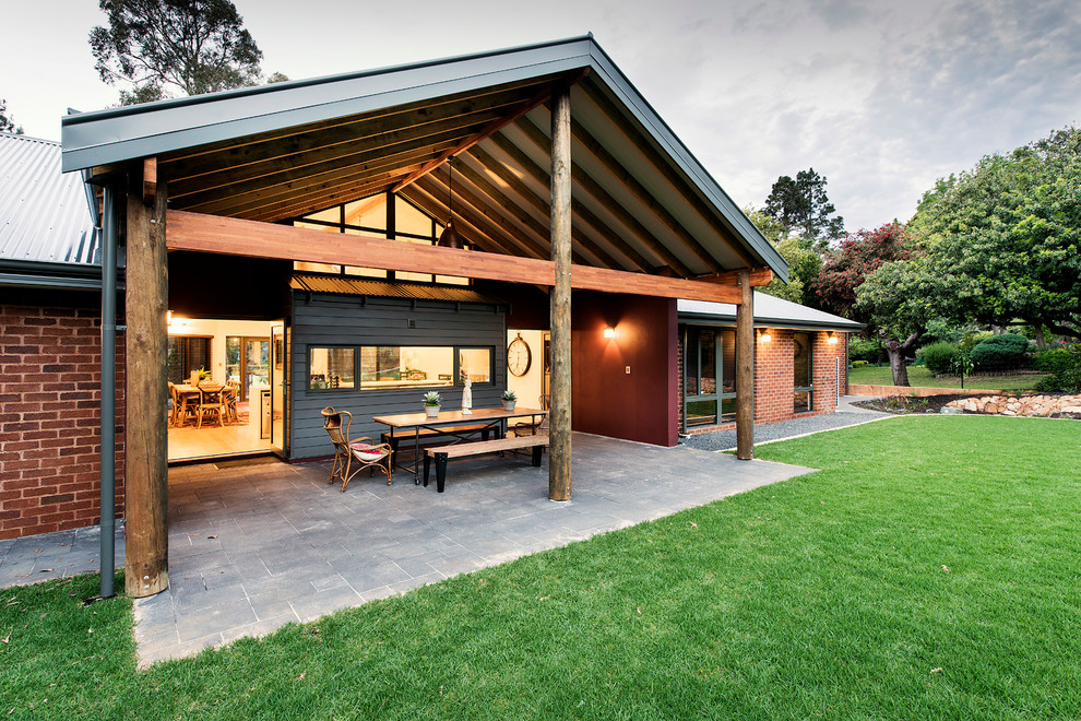 This is an example of a large traditional back patio in Perth with concrete paving and a pergola.