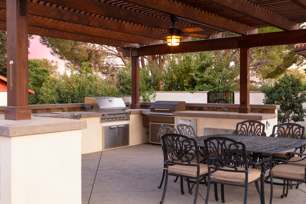 Inspiration for a large farmhouse back patio in Los Angeles with an outdoor kitchen, concrete paving and a pergola.