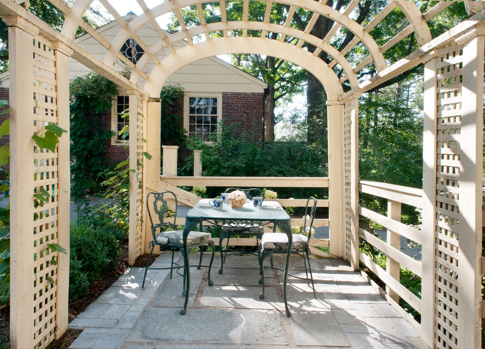 Inspiration for a timeless patio remodel in Boston with a pergola