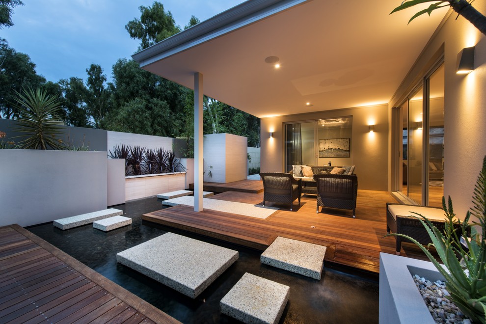 Design ideas for a contemporary back patio in Perth with a water feature, decking and a roof extension.