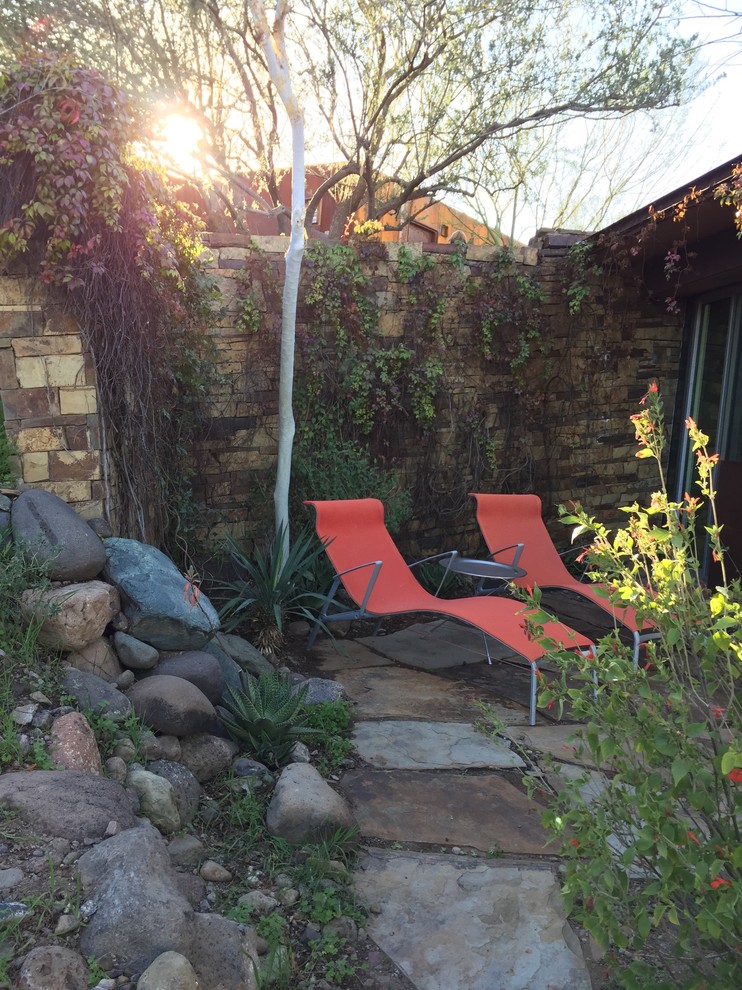 Inspiration for a large southwestern backyard stone patio remodel in Phoenix with no cover