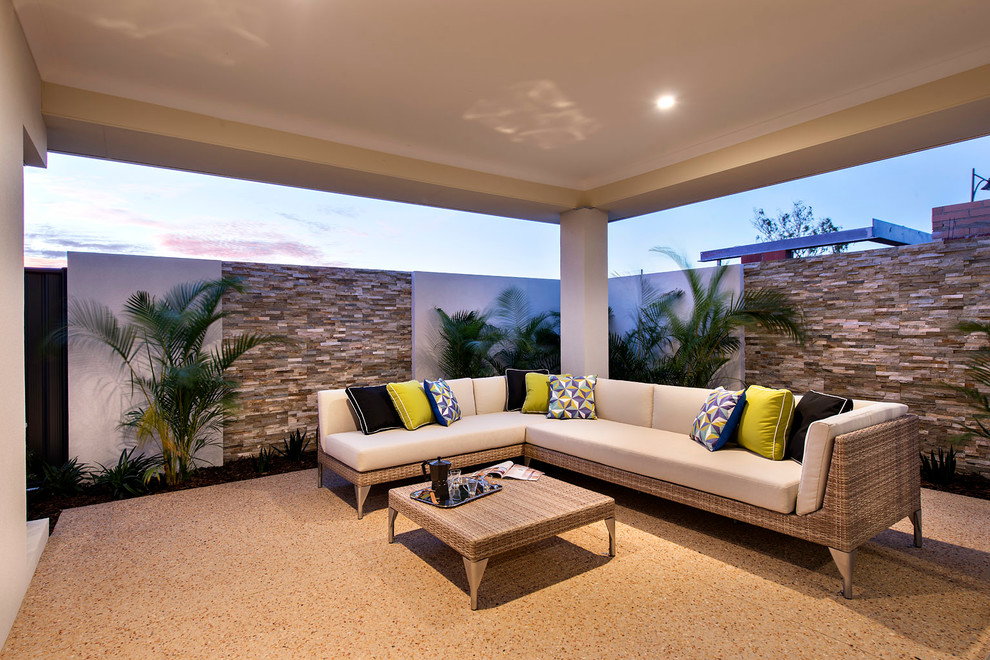 Example of a mid-sized trendy backyard patio design in Perth with a roof extension