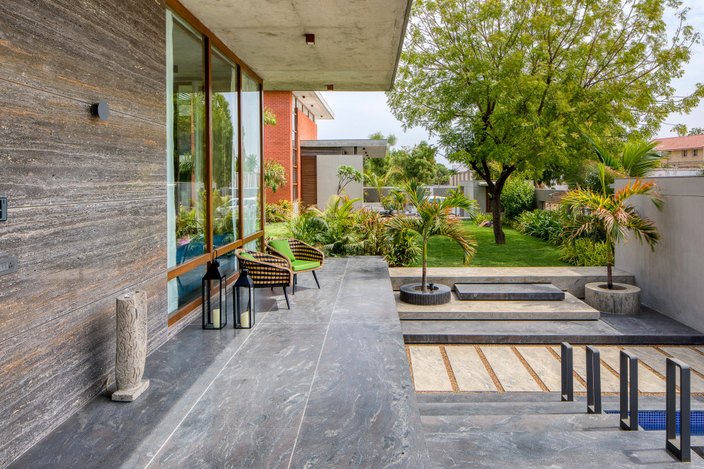 Contemporary patio in Ahmedabad with a roof extension.
