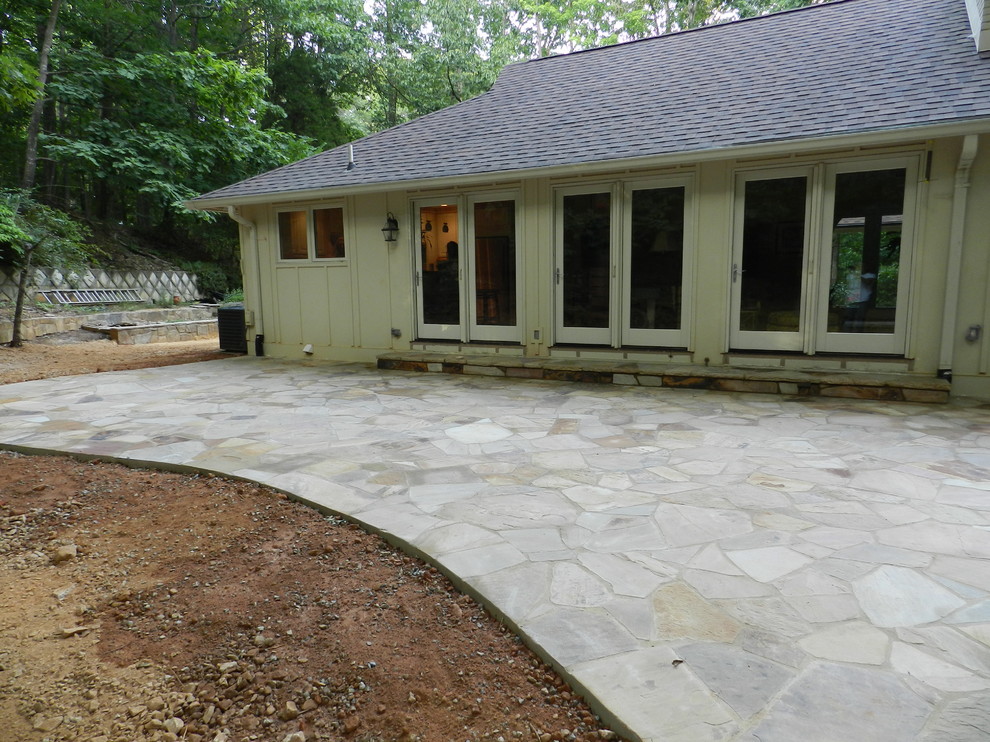 Inspiration for a small mediterranean backyard stone patio remodel in Raleigh with no cover