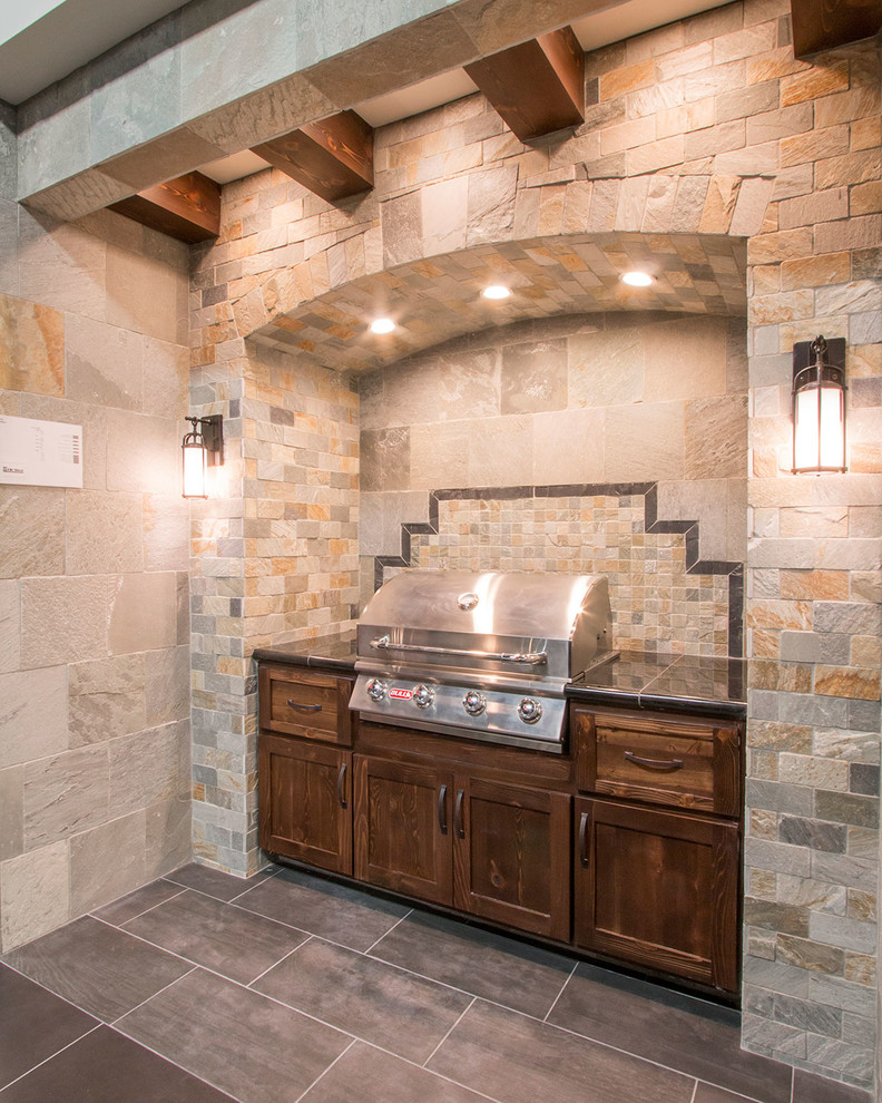 Inspiration for a stone patio kitchen remodel in Minneapolis with an awning