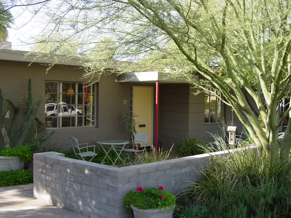 Mid-sized transitional front yard stone patio photo in Phoenix with no cover
