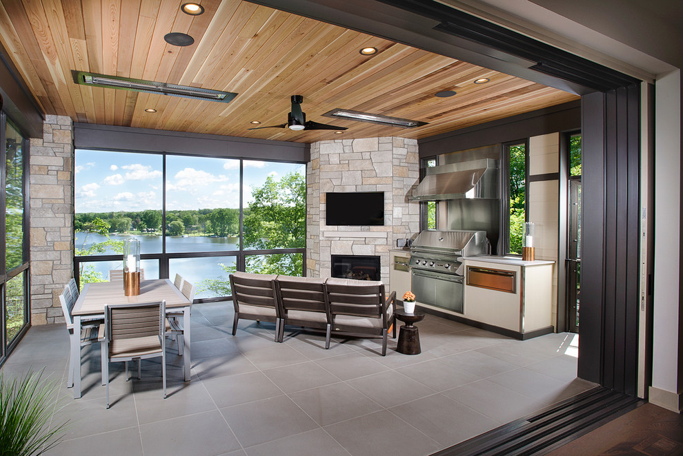 Inspiration for a contemporary tile patio remodel in Grand Rapids with a roof extension