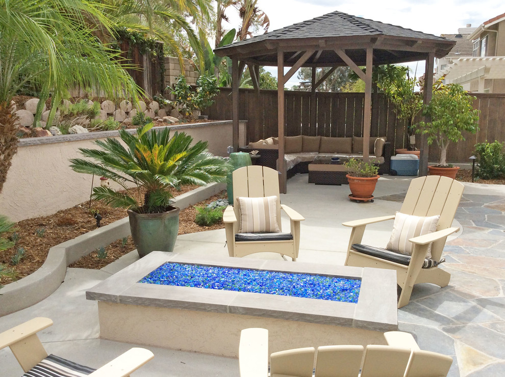 Inspiration for a small timeless backyard concrete patio remodel in San Diego with a gazebo and a fire pit