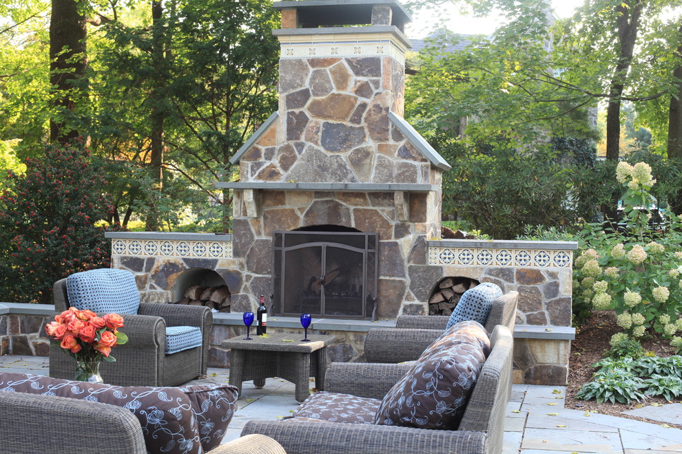 Patio - large traditional backyard stone patio idea in New York with a fire pit and a pergola