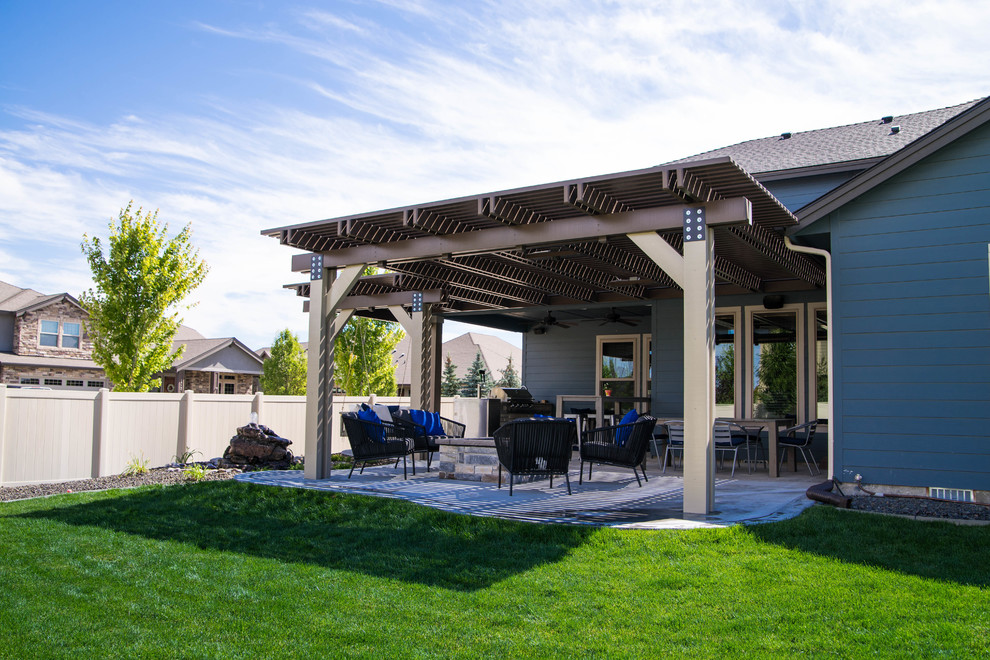 Inspiration for a large traditional back patio in Boise with a pergola.