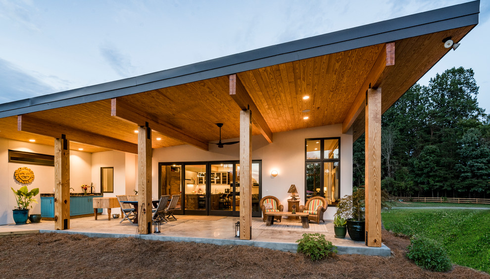 Idée de décoration pour une terrasse arrière minimaliste de taille moyenne avec une cuisine d'été et une extension de toiture.