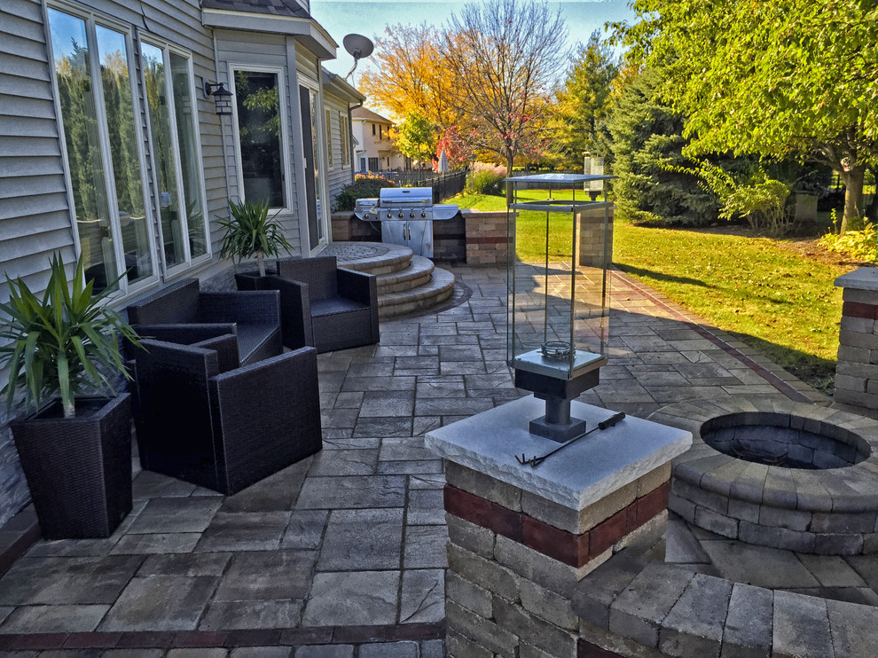 Inspiration for a small timeless backyard concrete paver patio remodel in Chicago with a fire pit and no cover