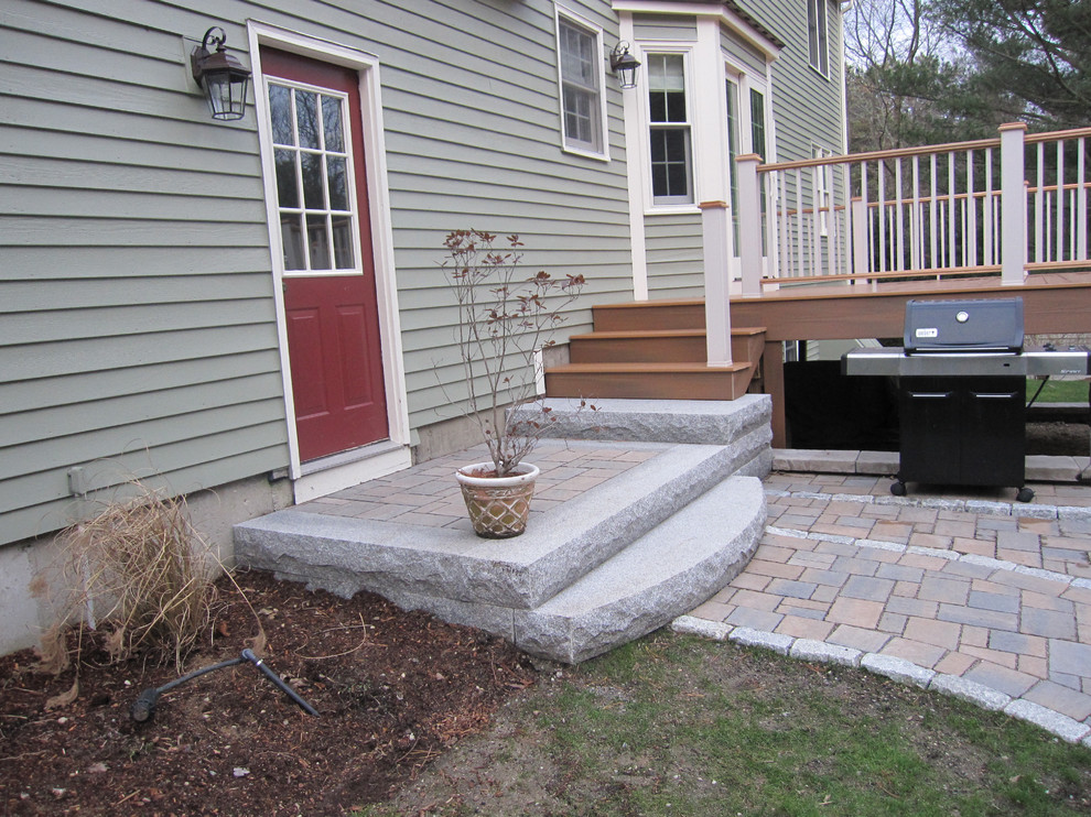 Inspiration for a large classic back patio in Boston with concrete paving.