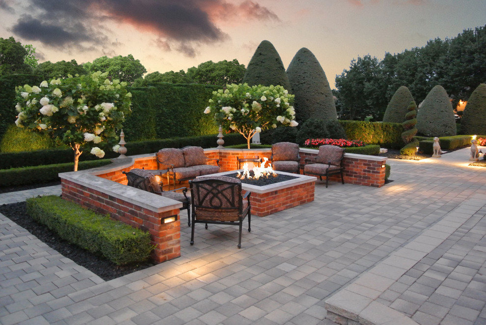 Large trendy backyard stone patio photo in Detroit with a fire pit and no cover
