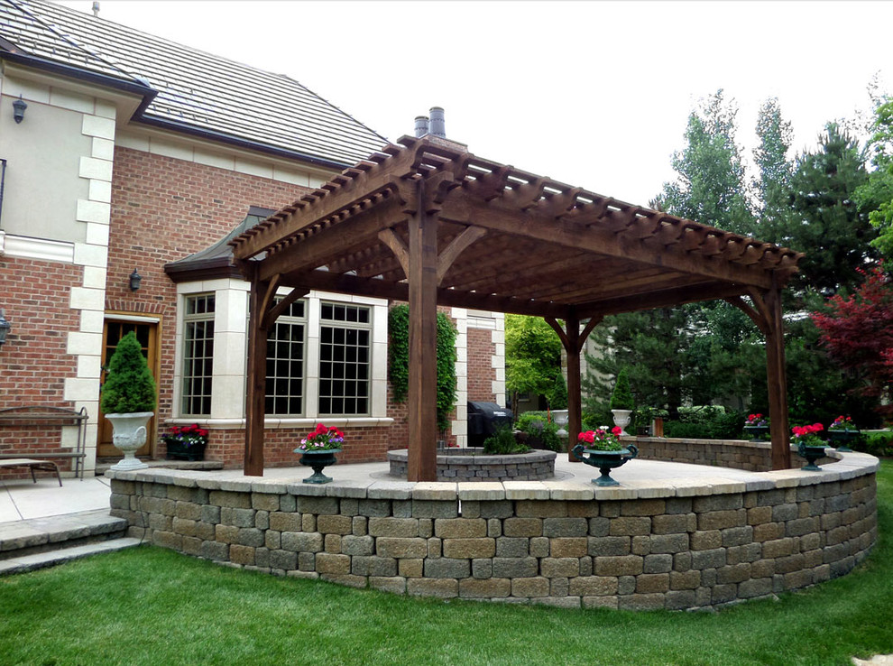 Example of a large classic courtyard patio design in Salt Lake City with a pergola