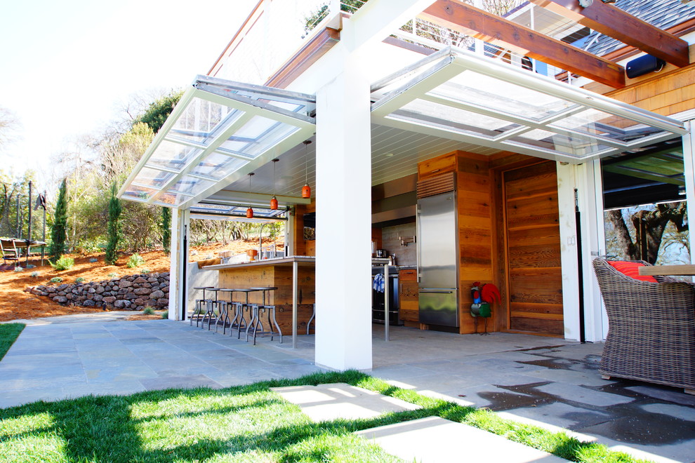 Example of a classic patio design in San Francisco with a roof extension