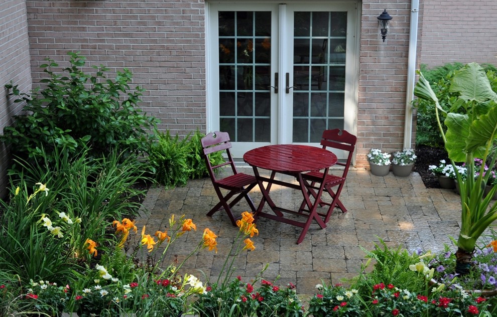 Esempio di un patio o portico classico con pavimentazioni in cemento