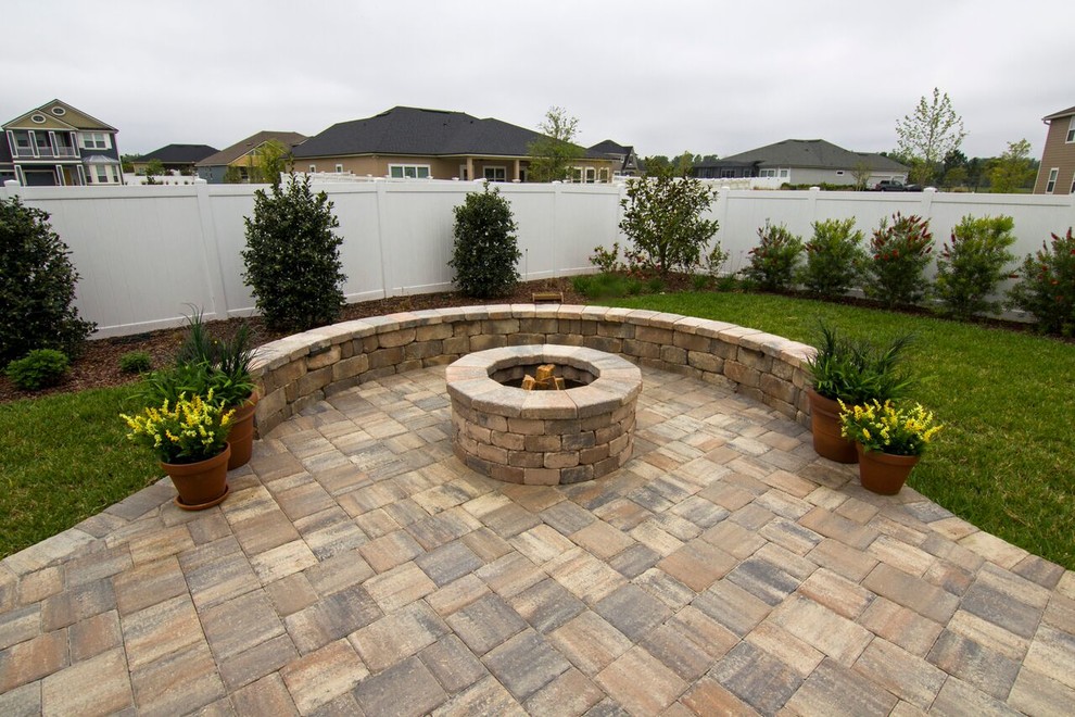 Patio - small traditional backyard brick patio idea in Jacksonville with a fire pit and no cover