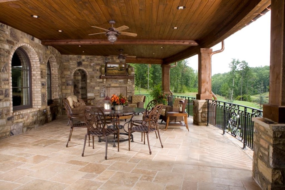 Patio - mid-sized traditional backyard stone patio idea in Nashville with a fire pit and a roof extension