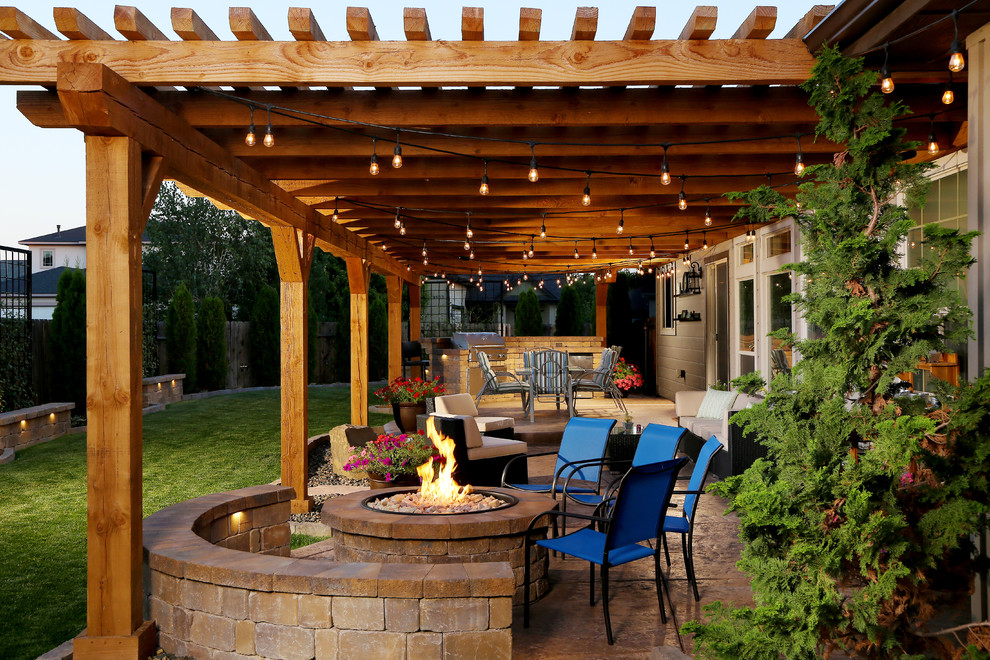 Inspiration for a mid-sized timeless backyard patio remodel in Boise with a fire pit and a pergola