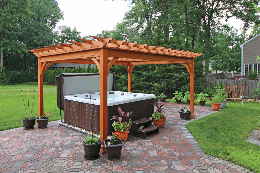 Concrete paver patio photo in Other with a pergola