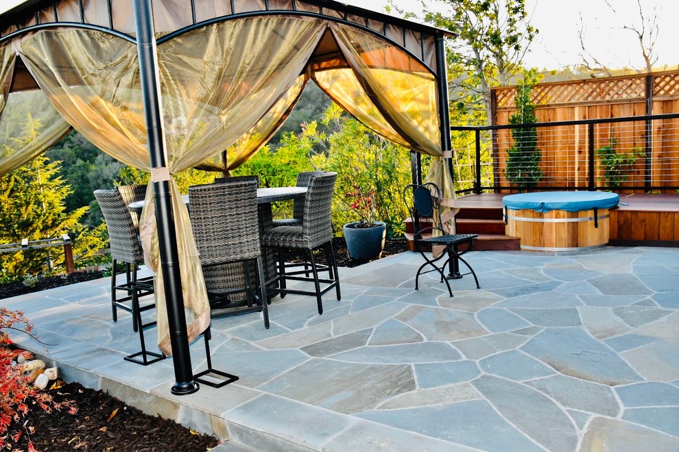 Inspiration for a mid-sized contemporary backyard stone patio remodel in San Francisco with a gazebo