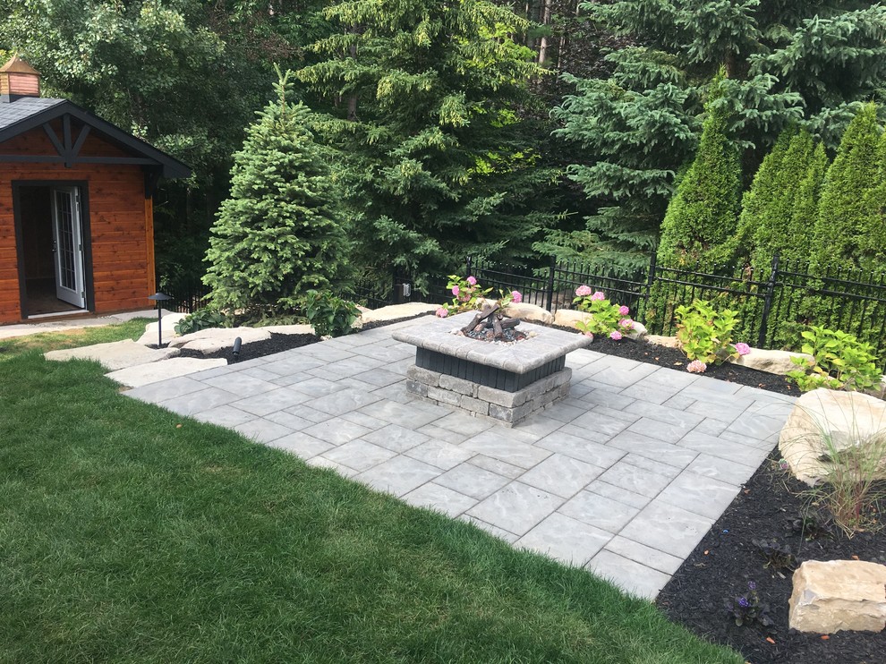 Inspiration for a medium sized traditional back patio in Toronto with a fire feature, concrete paving and no cover.
