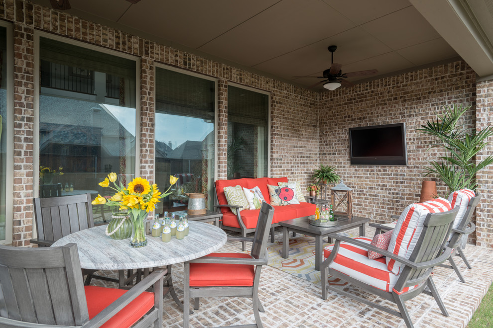 Photo of a medium sized classic back patio in Dallas with brick paving and a roof extension.