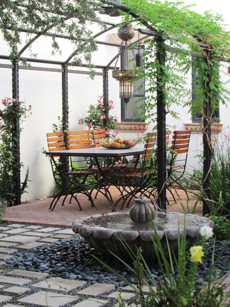 Photo of a mediterranean patio in Phoenix with a water feature.