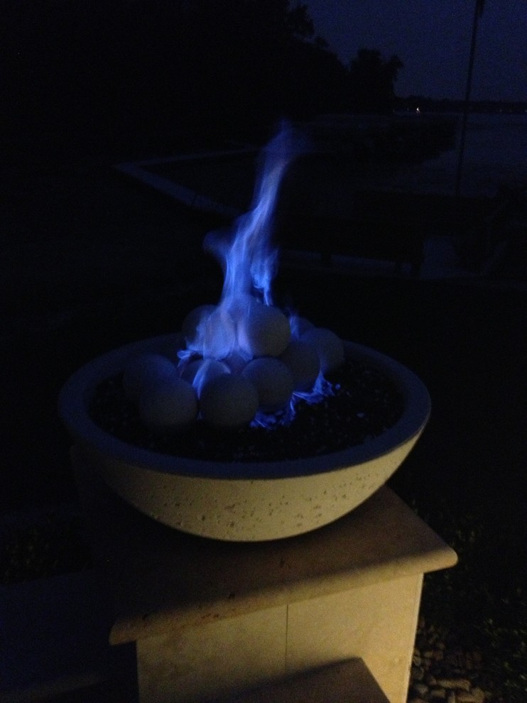 Small minimalist backyard stone patio photo in Indianapolis with a fire pit